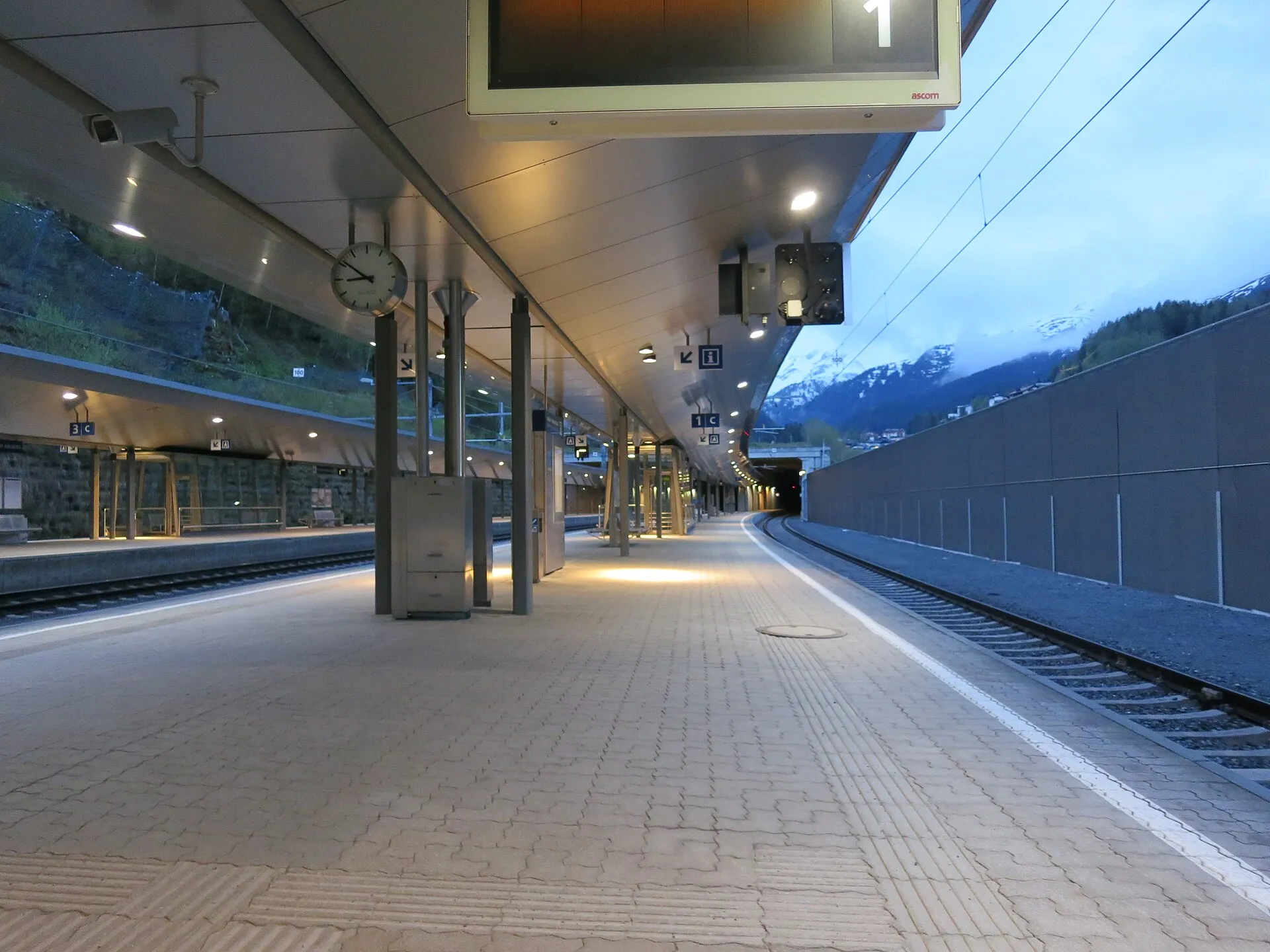 The covered platform of the new St. Anton am Arlberg station with mountains beyond the far end.