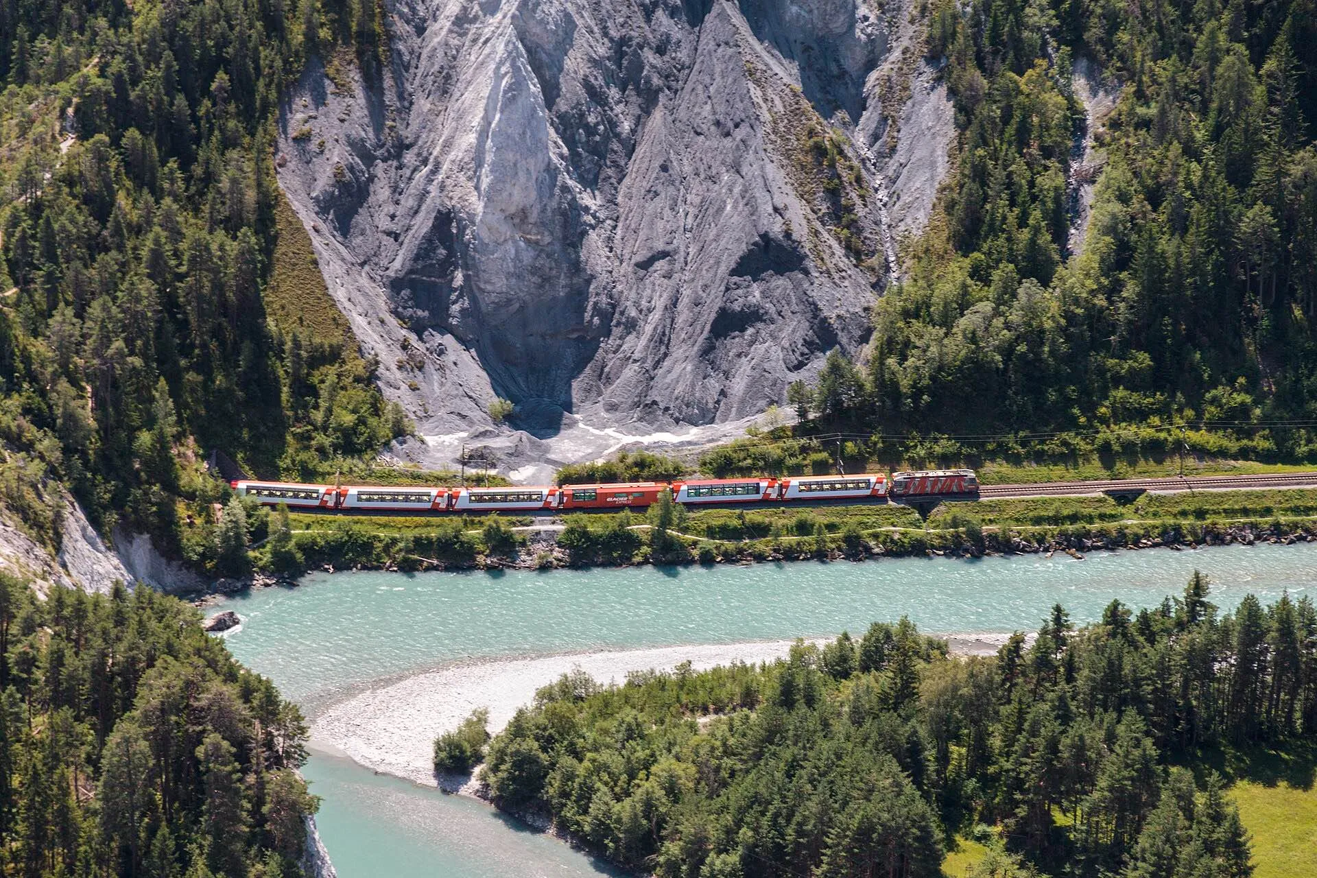 The Glacier Express following the Rhine through the pale cliffs of the Ruinaulta gorge.