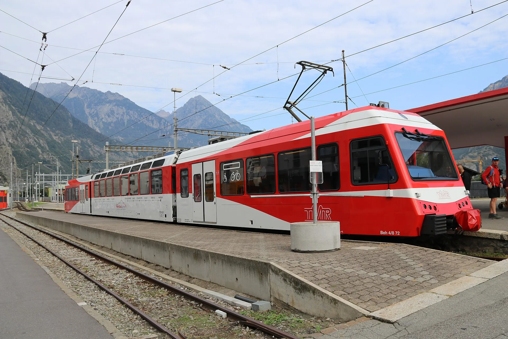 A red and white TMR train waiting at the narrow gauge platform in Martigny.