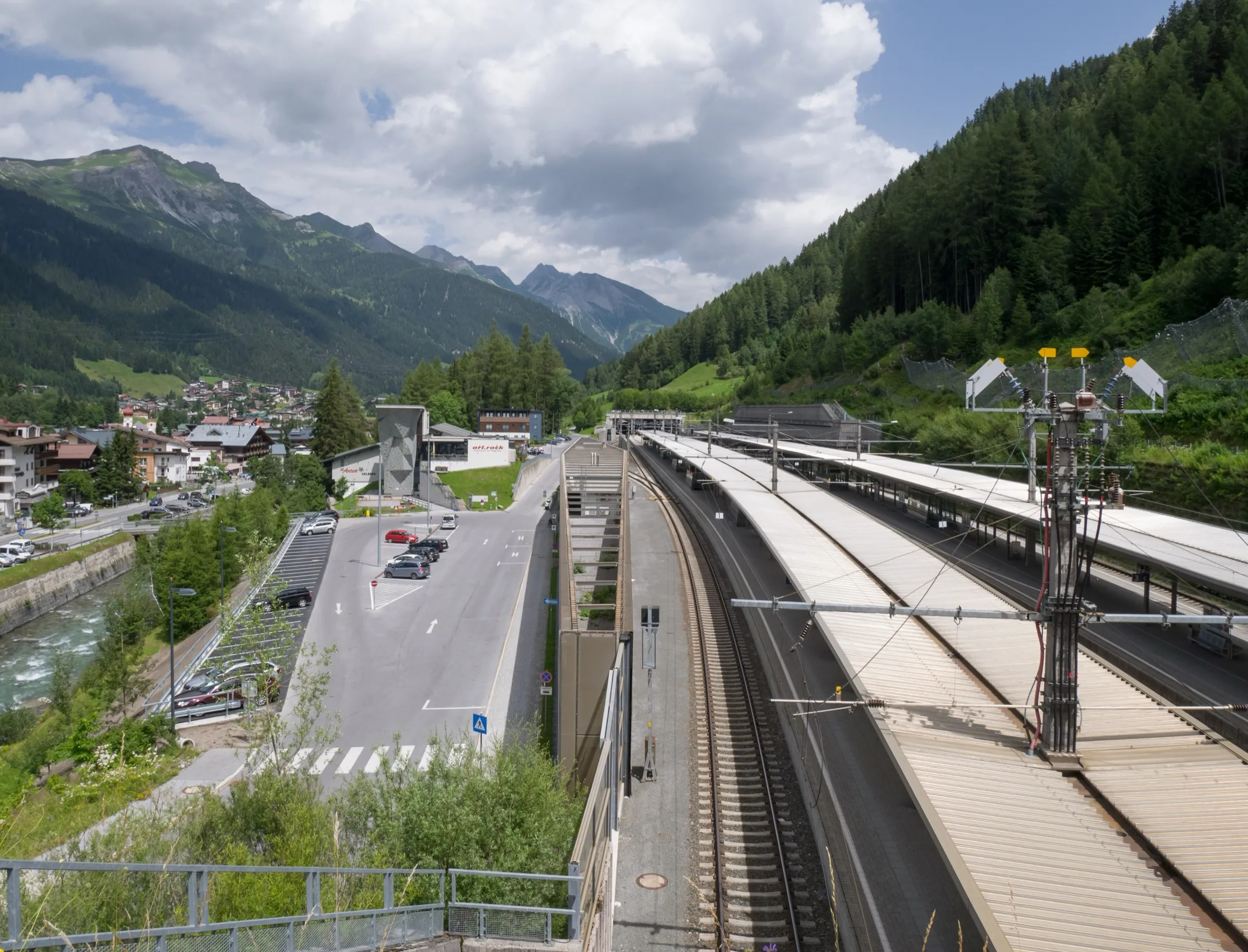St Anton am Arlberg station platforms seen from above with the village and the Arlberg peaks beyond.
